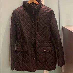 Black quilted jacket with leather shoulders.